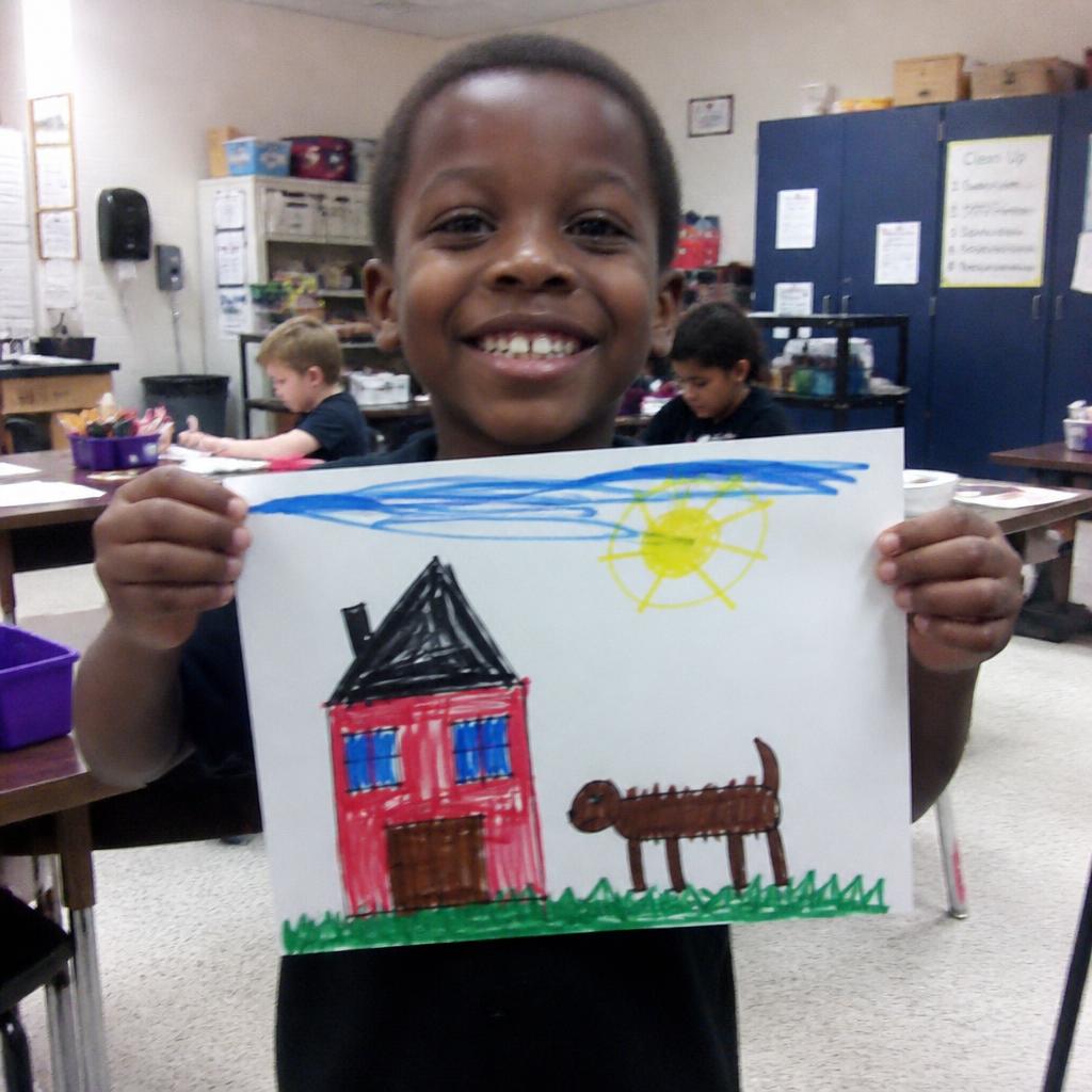Kids in a live art class showcasing their drawings 3